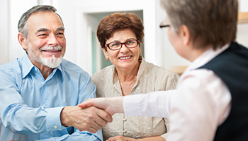 Senior man visiting an estate planning agent and shaking hands